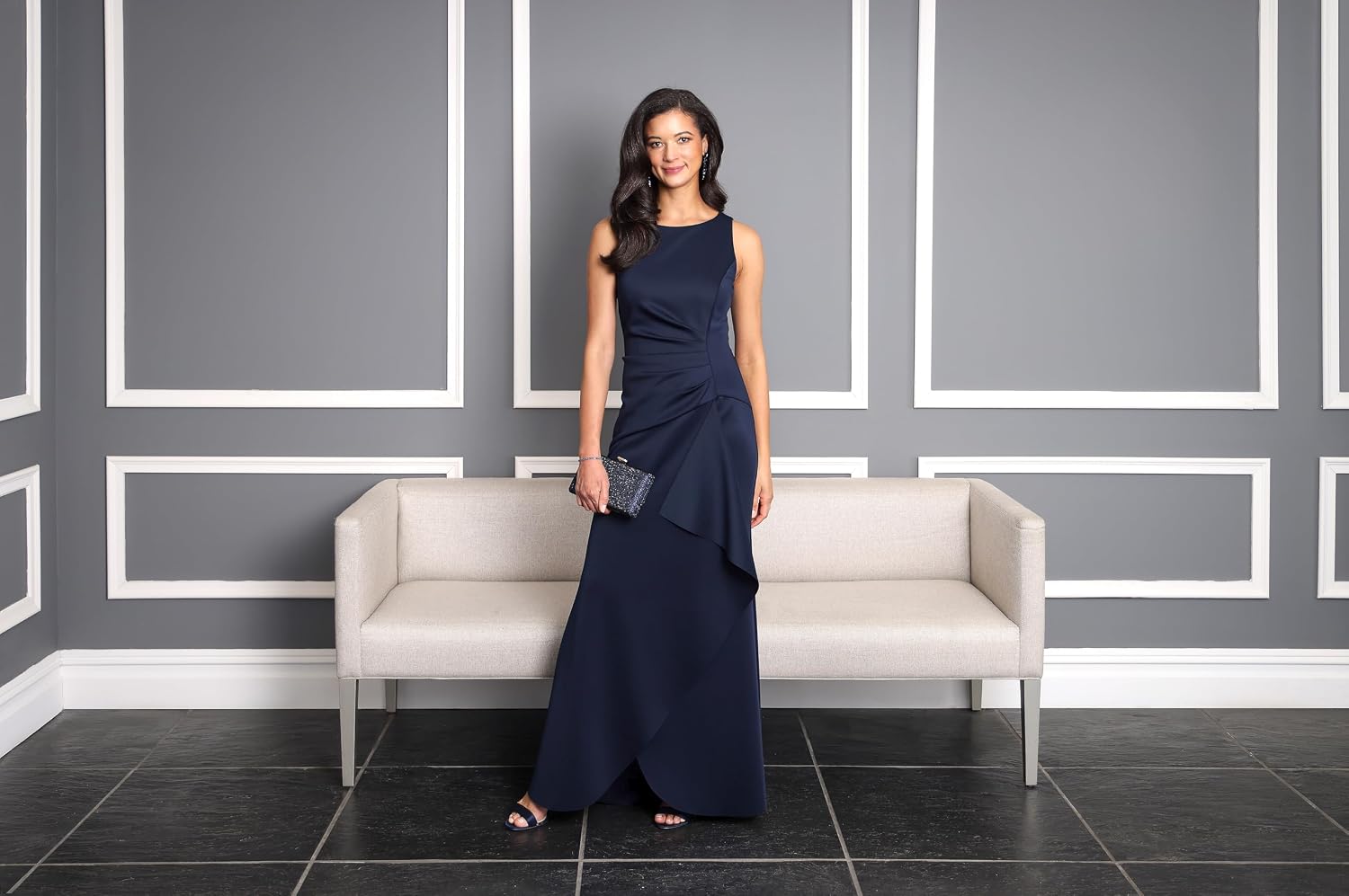 Sleeveless stretch scuba crepe mother of the bride dress in [color] with tucked waist and cascade detail skirt, worn for formal wedding event — view 3